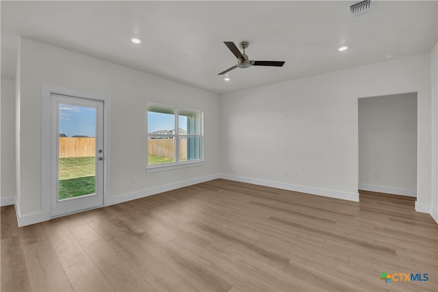 unfurnished room with ceiling fan and light wood-type flooring