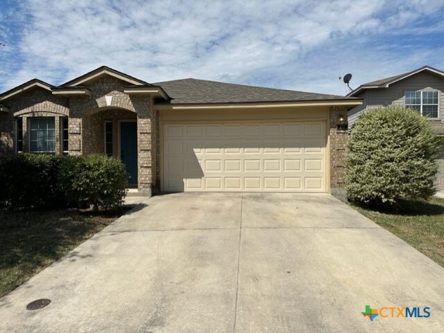 221 Roadrunner Ave, New Braunfels, TX 78130 - view of front of property featuring brick siding, driveway, and an attached garage