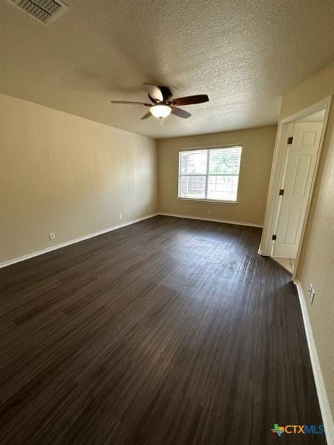 221 Roadrunner Ave, New Braunfels, TX 78130 - spare room with a ceiling fan, dark wood-style flooring, and a textured ceiling