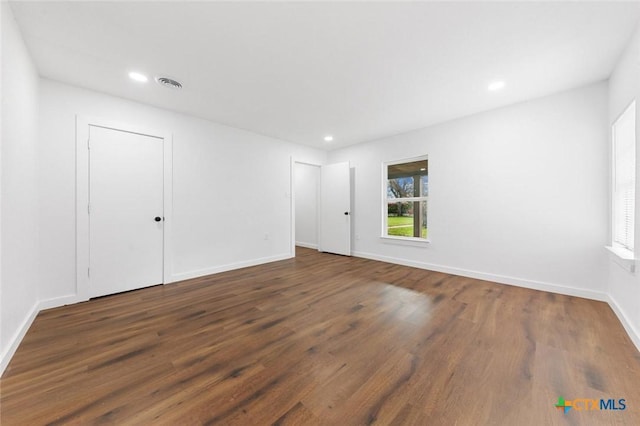 unfurnished room featuring dark hardwood / wood-style floors