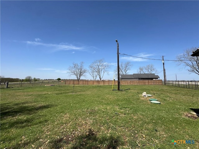 view of yard with a rural view and fence