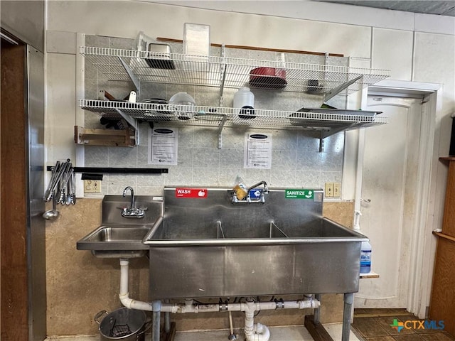 kitchen with decorative backsplash and a sink