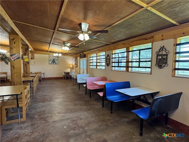 dining room with unfinished concrete floors, a ceiling fan, and baseboards