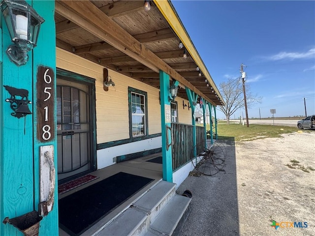 doorway to property featuring covered porch