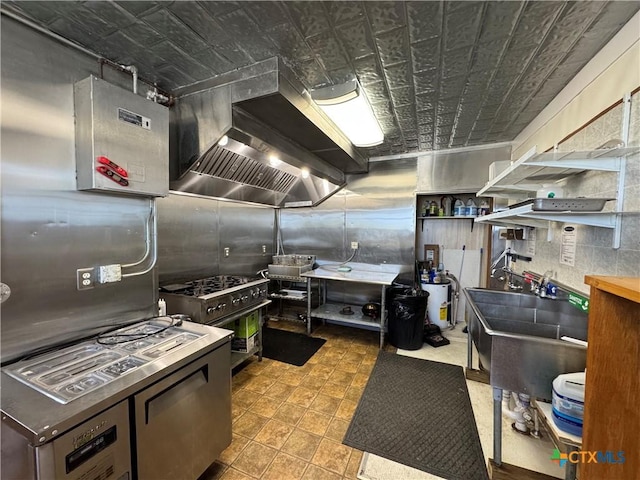 kitchen with wall chimney exhaust hood, high end stainless steel range oven, and a sink
