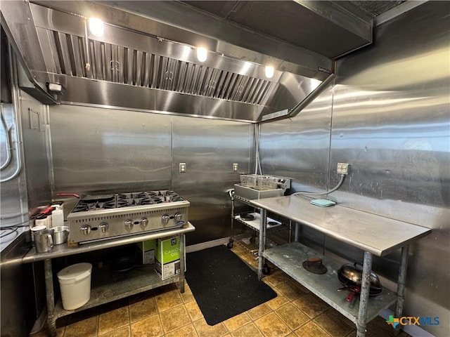 kitchen featuring tile patterned flooring and custom range hood
