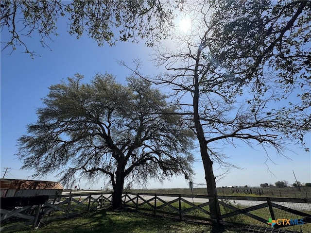 water view with a rural view and fence