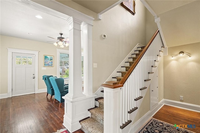 staircase featuring hardwood / wood-style flooring, ceiling fan, and ornamental molding