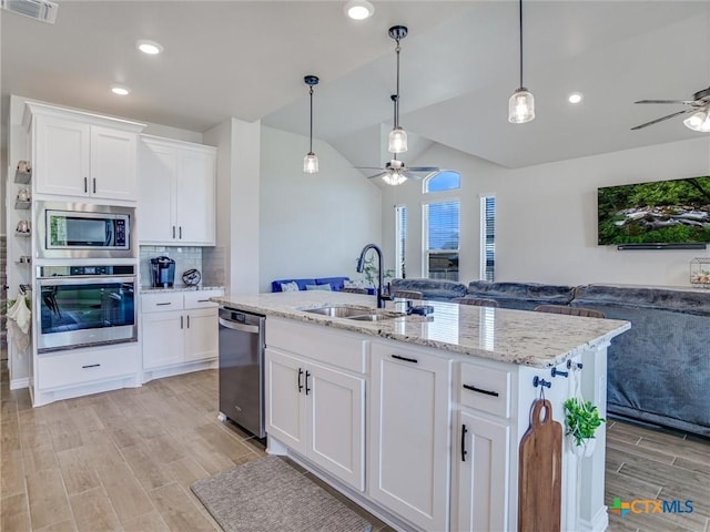 1701 Meadow Crest Dr, Salado, TX 76571 - kitchen with appliances with stainless steel finishes, ceiling fan, a sink, open floor plan, and vaulted ceiling