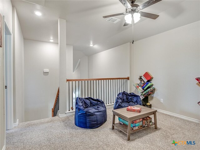 sitting room with carpet and ceiling fan