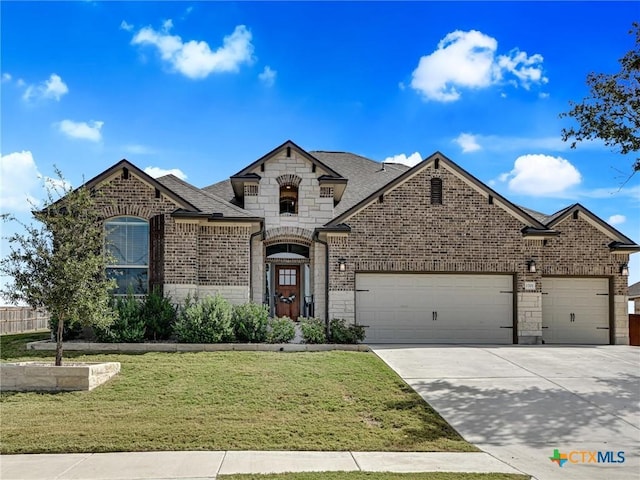 1701 Meadow Crest Dr, Salado, TX 76571 - french country style house featuring a garage, brick siding, concrete driveway, stone siding, and a front yard
