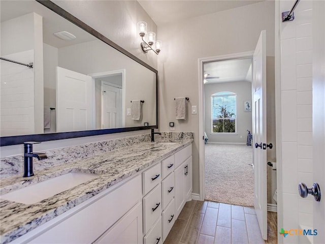 1701 Meadow Crest Dr, Salado, TX 76571 - bathroom featuring double vanity, baseboards, wood tiled floors, and ceiling fan