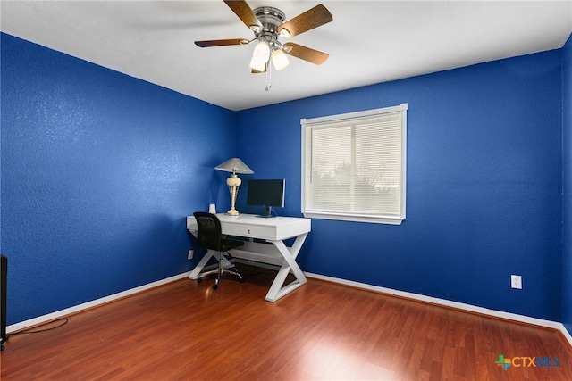 unfurnished office featuring ceiling fan and wood-type flooring