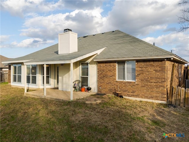 rear view of property with a patio area and a yard