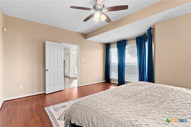 bedroom featuring ceiling fan and dark hardwood / wood-style flooring