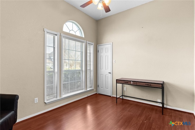 spare room with ceiling fan, dark hardwood / wood-style flooring, and vaulted ceiling