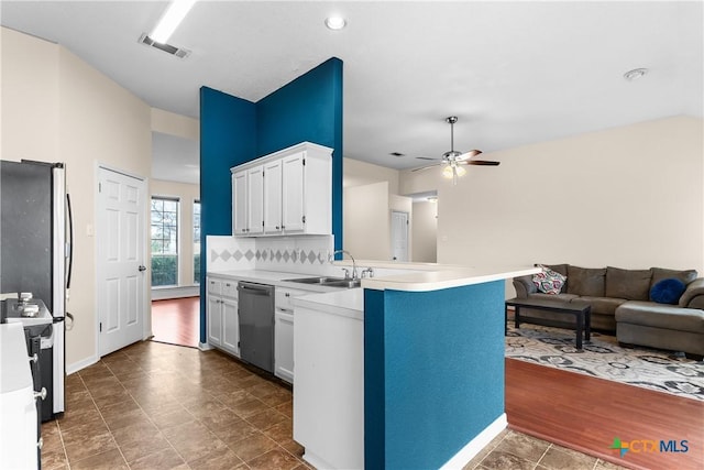 kitchen with white cabinetry, ceiling fan, backsplash, kitchen peninsula, and appliances with stainless steel finishes