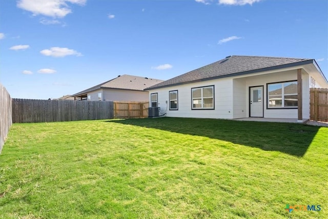 back of property with a yard and central AC unit