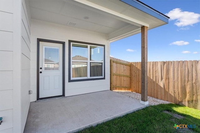 entrance to property featuring a patio area