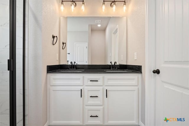 bathroom with vanity and an enclosed shower