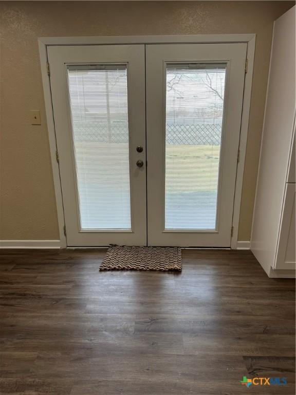 entryway featuring french doors, baseboards, and wood finished floors