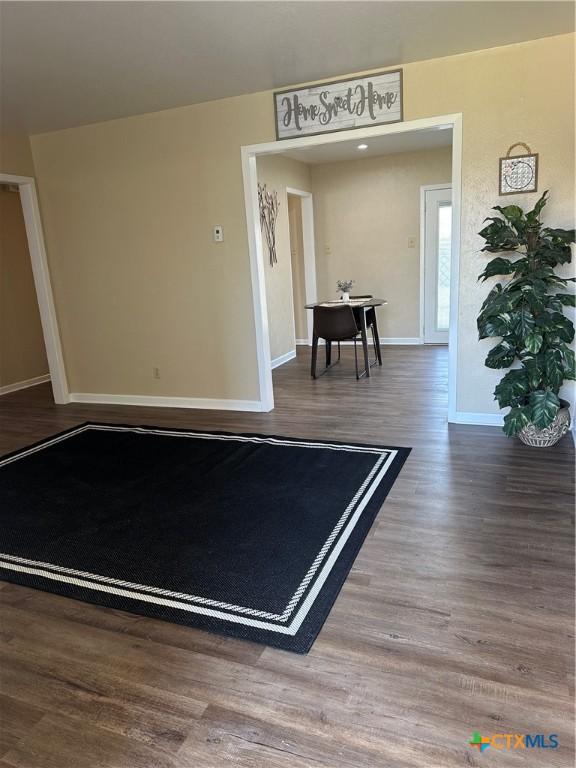 interior space featuring wood finished floors and baseboards