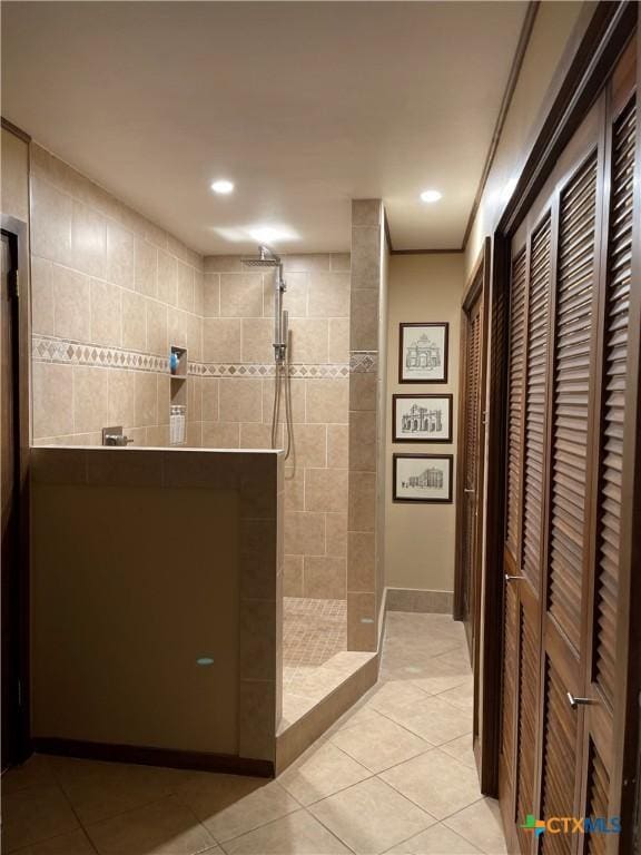 bathroom featuring tiled shower and tile patterned floors