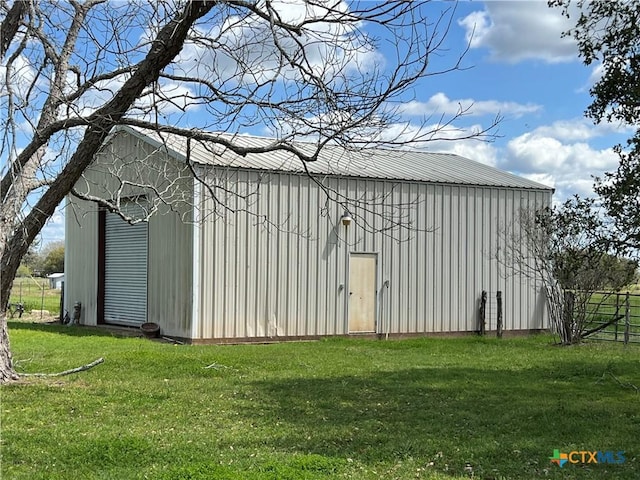 view of outdoor structure featuring a lawn