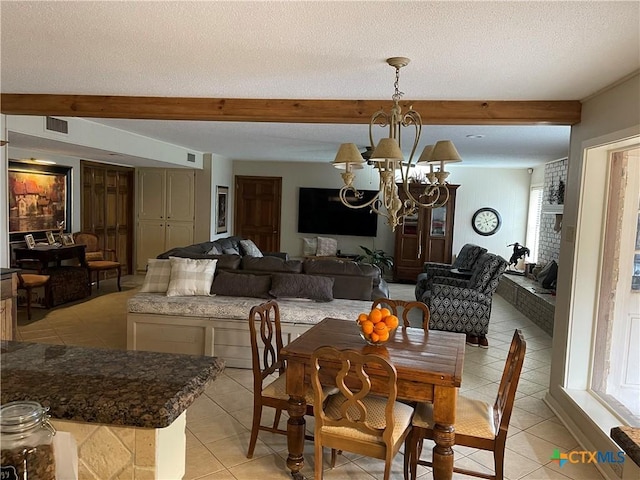 dining room with beamed ceiling, light tile patterned floors, a notable chandelier, and a textured ceiling