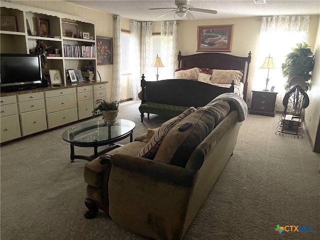 carpeted bedroom featuring multiple windows and ceiling fan