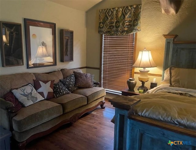 living room featuring lofted ceiling and dark hardwood / wood-style floors