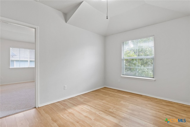 unfurnished room with a wealth of natural light and light hardwood / wood-style flooring