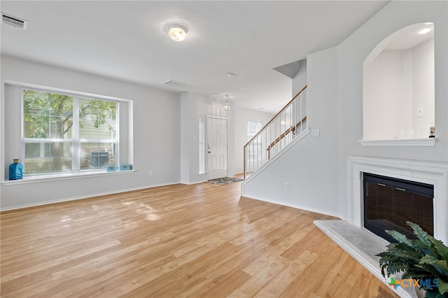 unfurnished living room featuring light wood-type flooring