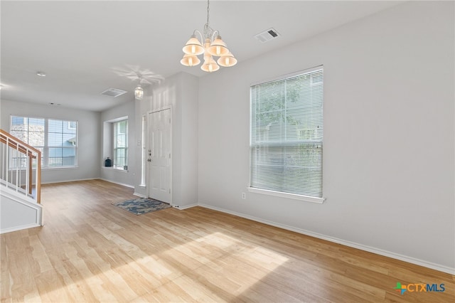 entrance foyer with a chandelier and light hardwood / wood-style flooring