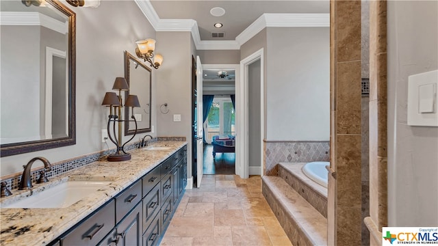 bathroom featuring vanity, a relaxing tiled tub, and ornamental molding