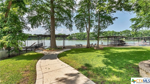 view of dock featuring a yard and a water view