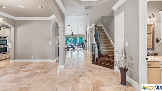 foyer featuring ornamental molding