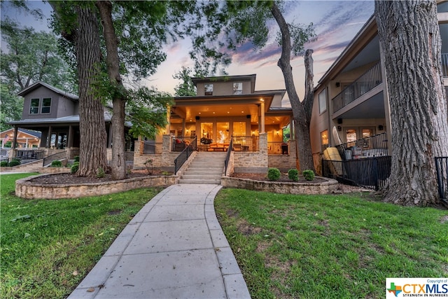 view of front of property with a lawn and covered porch