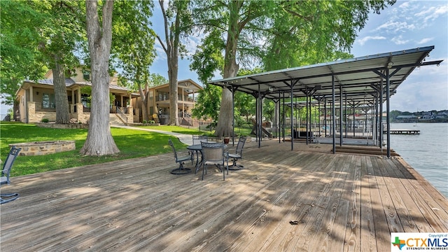 view of dock featuring a lawn and a deck with water view