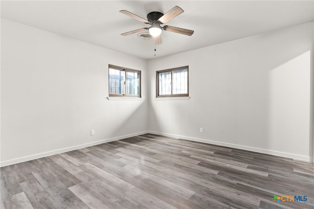 spare room featuring hardwood / wood-style floors and ceiling fan