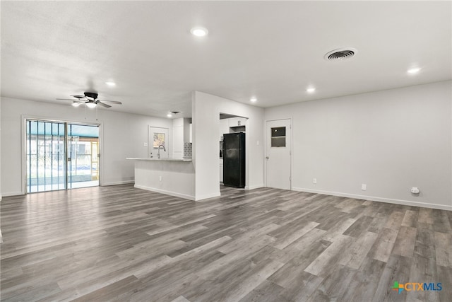 unfurnished living room with light hardwood / wood-style floors and ceiling fan