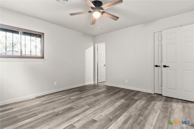 empty room featuring ceiling fan and light wood-type flooring