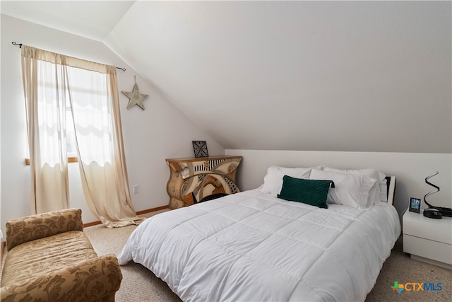 carpeted bedroom featuring vaulted ceiling