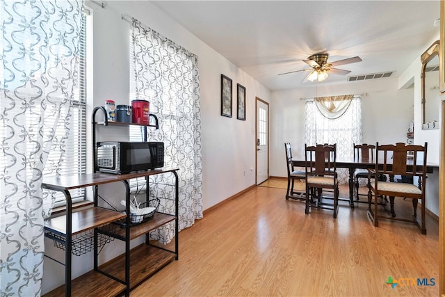 dining space featuring light hardwood / wood-style flooring and ceiling fan