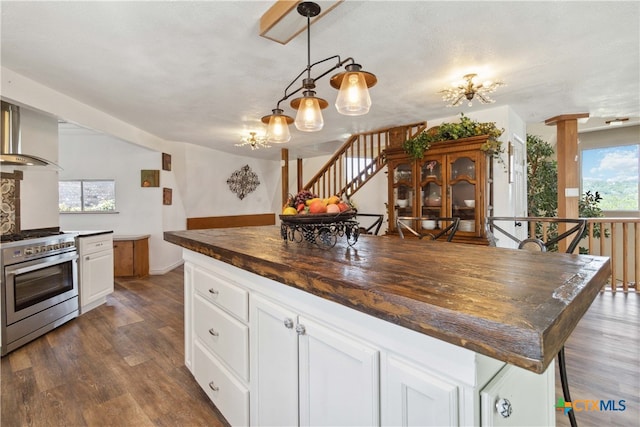 kitchen featuring white cabinetry, dark hardwood / wood-style floors, a center island, wood counters, and high end range