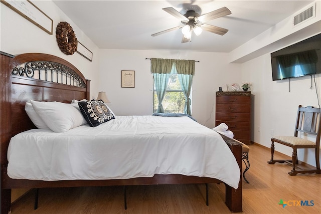 bedroom featuring ceiling fan and light hardwood / wood-style flooring