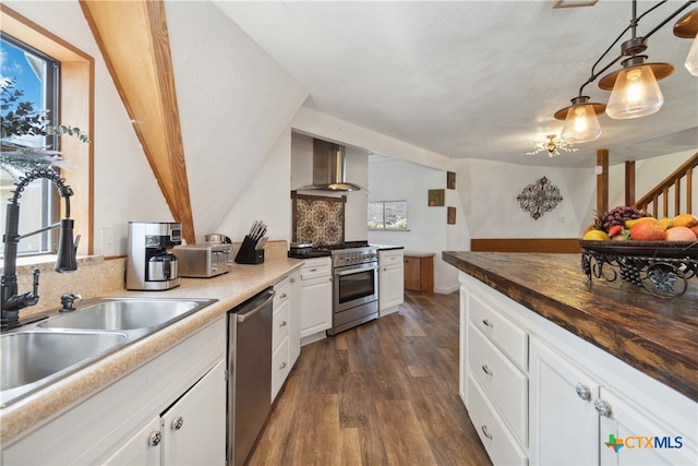 kitchen with white cabinetry, stainless steel appliances, wall chimney exhaust hood, and a healthy amount of sunlight