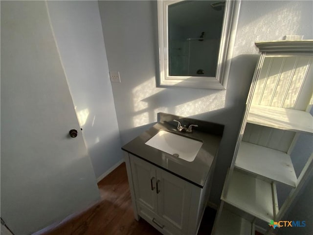 bathroom with vanity and wood-type flooring