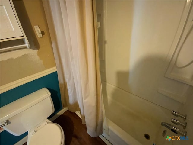 bathroom featuring hardwood / wood-style flooring and toilet