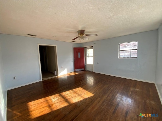 spare room with a textured ceiling, dark hardwood / wood-style floors, and ceiling fan